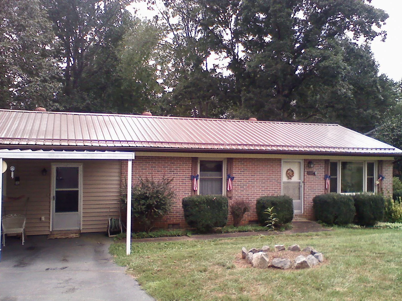 Bronze metal roof and carport on a brick ranch home — Roof Repair work by our crew in Pawleys Island